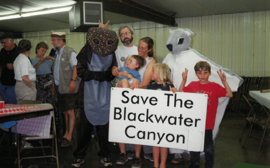 group of people with a sign that says "Save the Blackwater Canyon"